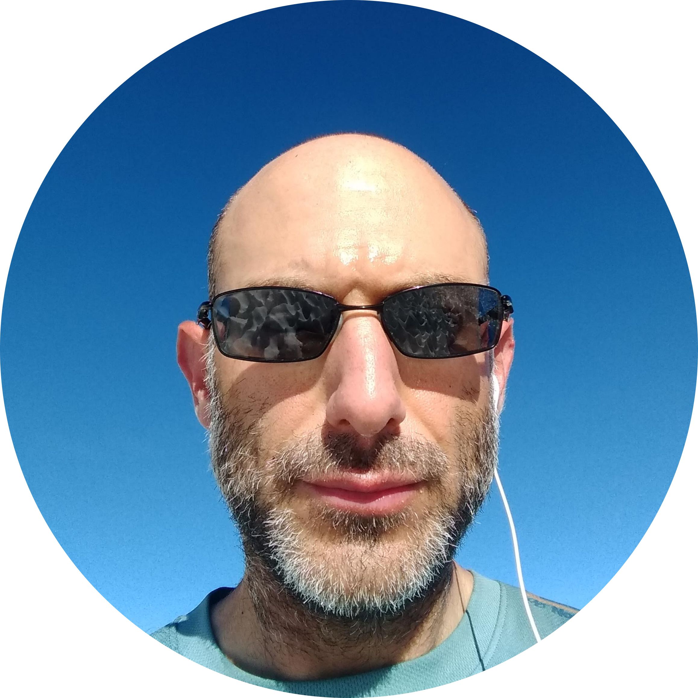 Photo of Itamar Goldminz with sunglasses and headphones.