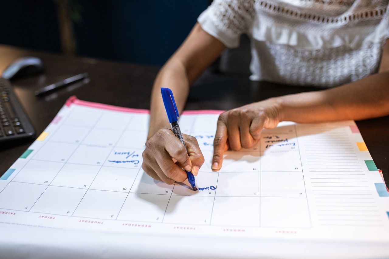 Person planning on calendar; photo by RODNAE Productions